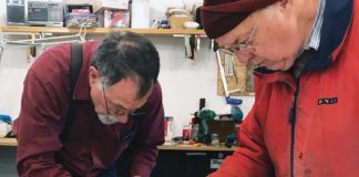 Rion Bourgeois (left) and Philip Groelz test the tank for leaks.